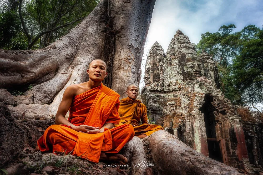 Monks meditate at the North Gate of Angkor Thom, Siem Reap, Cambodia.