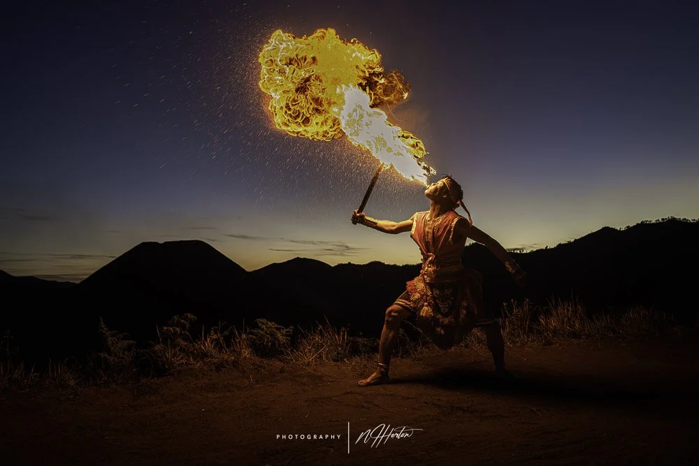 Sunset over mount Bromo with fire eater Indonesia.