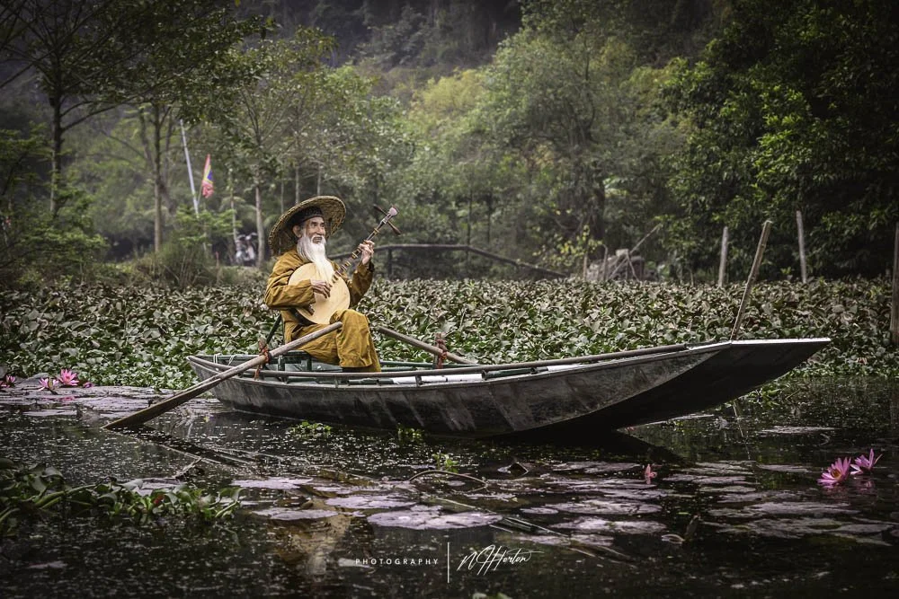 Fishing boat at dawn on Ba Be Lake, North Vietnam.