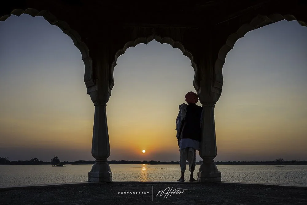 Man watches sun set Rajasthan India