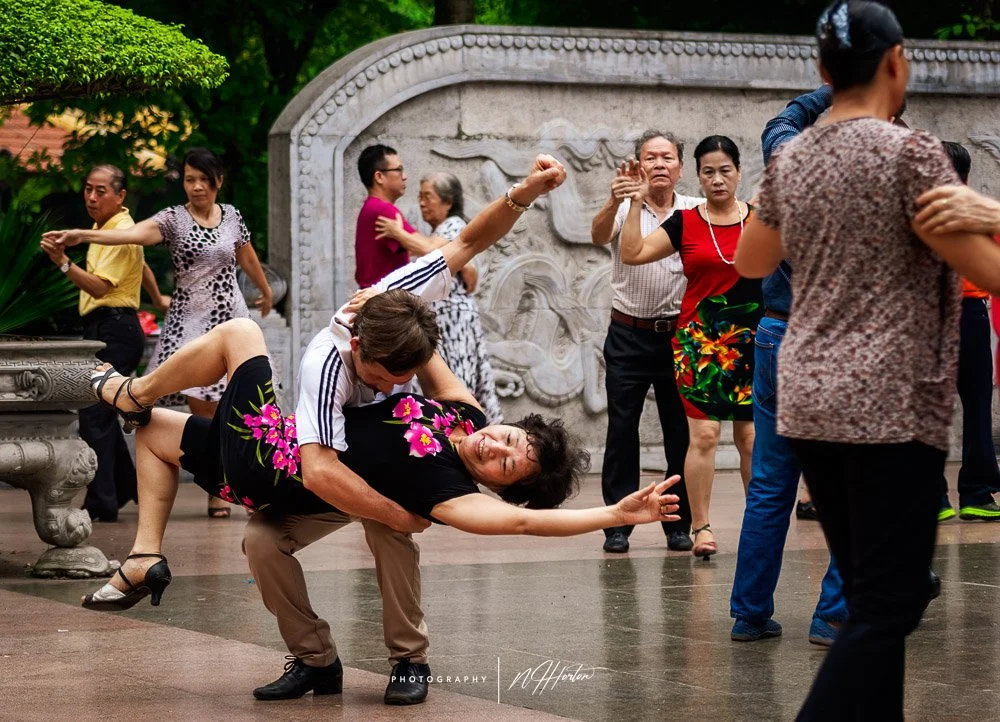 Early morning ballroom dancers , Hoan Kiem Lake, Hanoi, Vietnam.