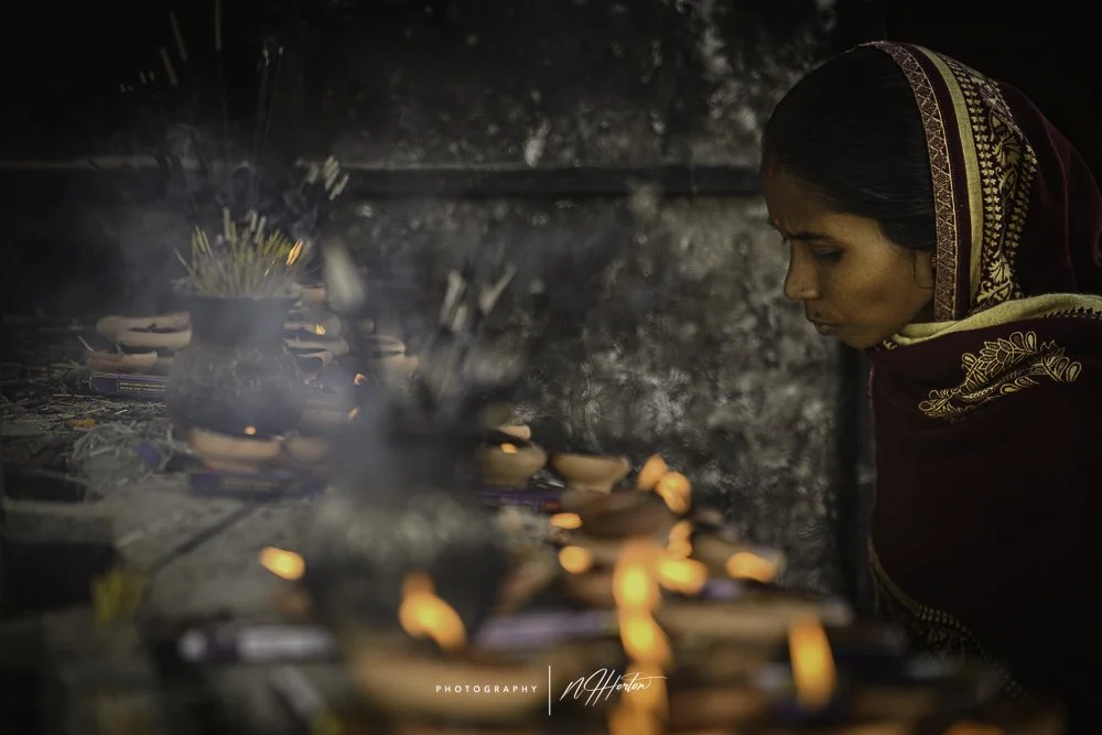 Lady-lighting-candles-at-Shiva-Dol-temple-Sivasagar-Assam-India