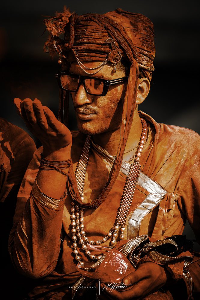 Man-covered-in-paint-at-Holi-festival-Nandgoan-India
