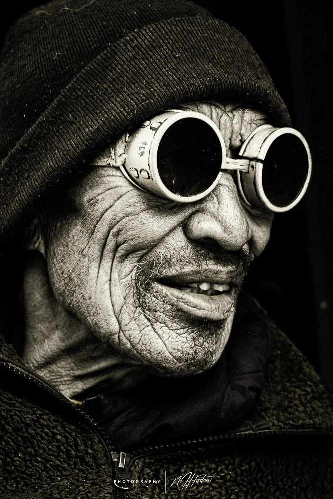 Portrait of man with old sun glasses, Mustang, Nepal