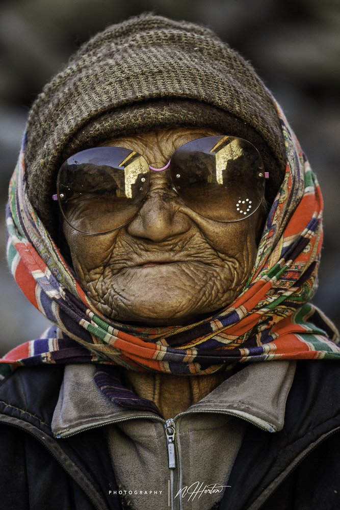 Kashmir portrait of old lady with sun glasses Zanskar