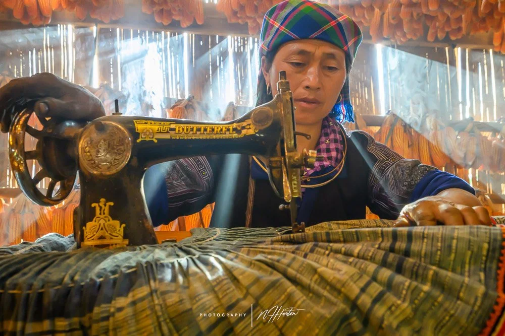 Local hill-tribe making clothes, Sapa, North Vietnam.