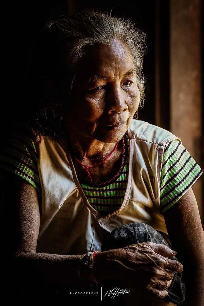 Portrait of woman in window in Laos