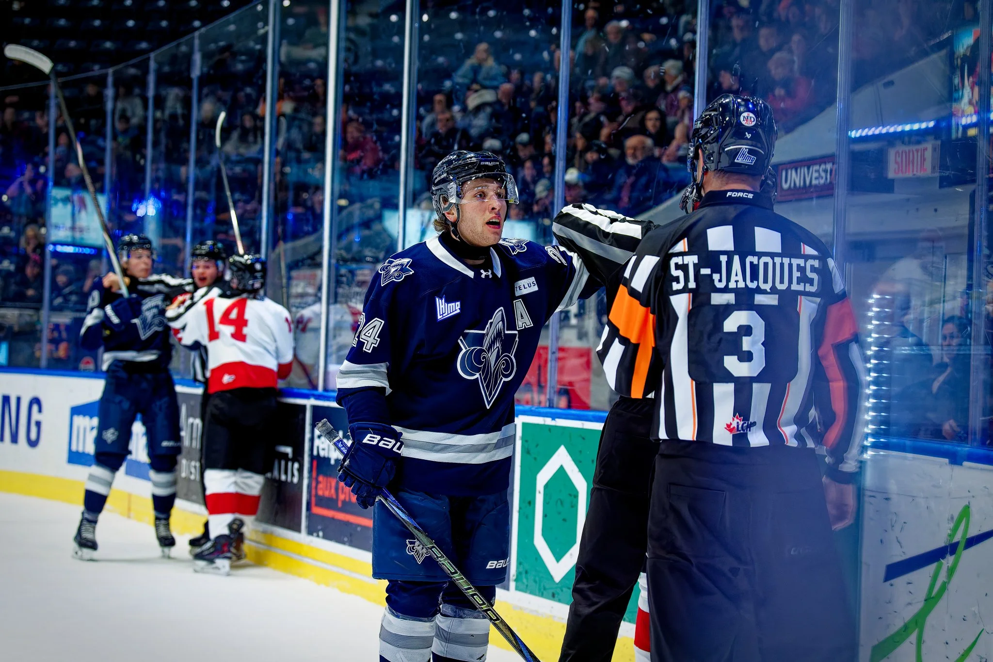 A hockey player in a blue jersey with an 