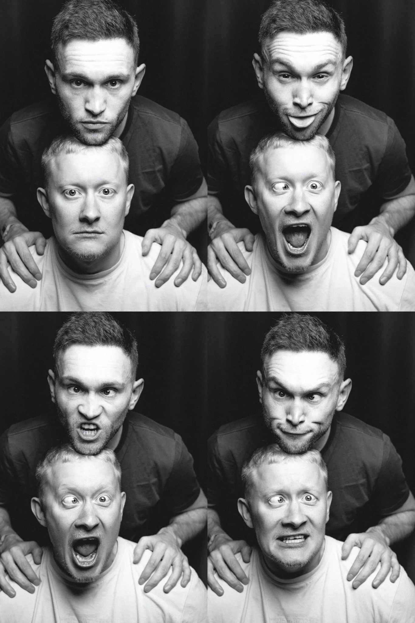 Four black-and-white photo booth images of two men making different facial expressions, positioned in a grid with two images on top and two on the bottom. The man in front appears surprised or scared, while the man behind has a serious or playful exp