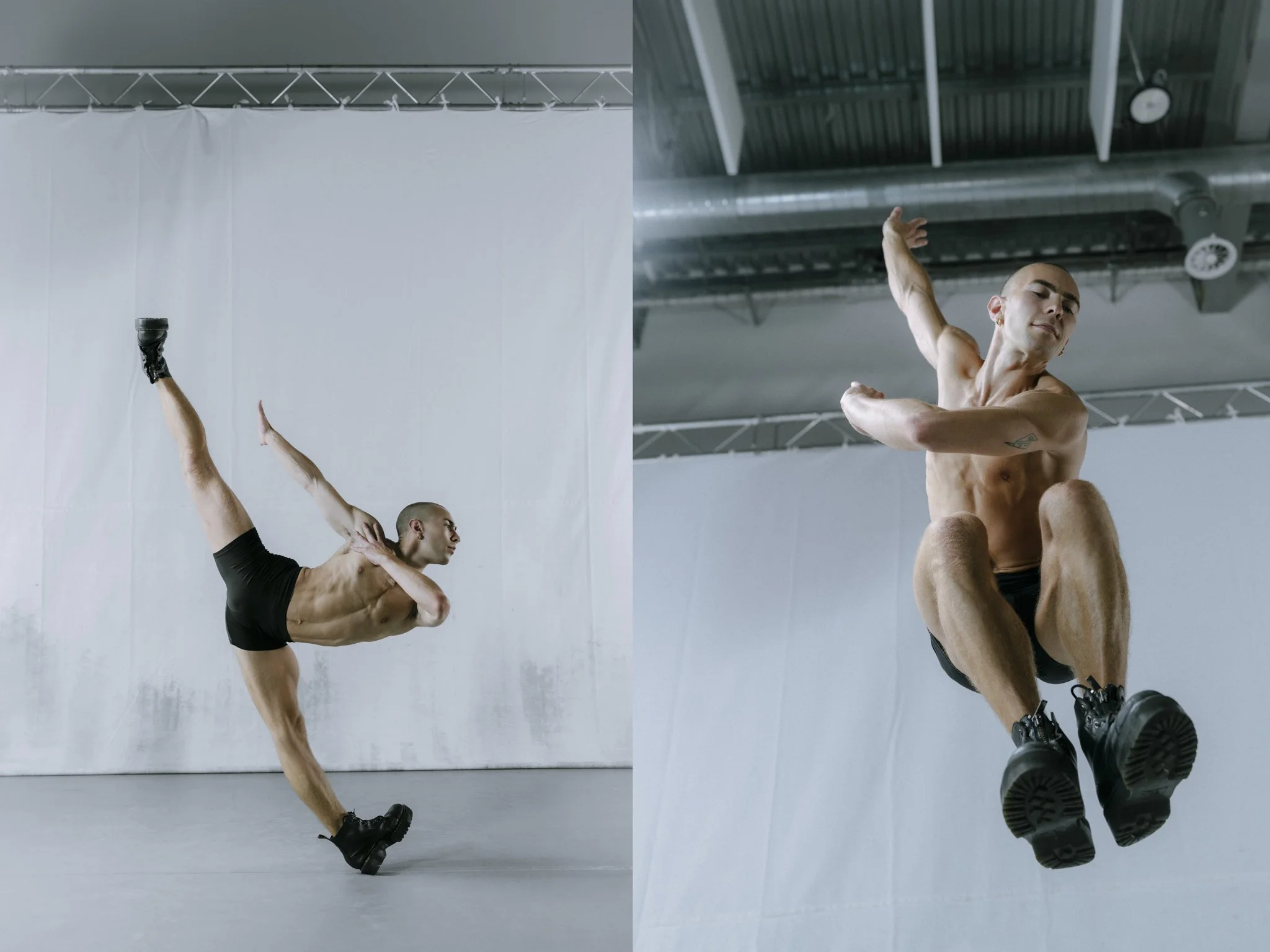Two male dancers practicing dance moves in an industrial studio, one performing a pose with arms and legs extended, and the other sitting on the floor with a similar pose, both wearing black shoes and minimal clothing.
