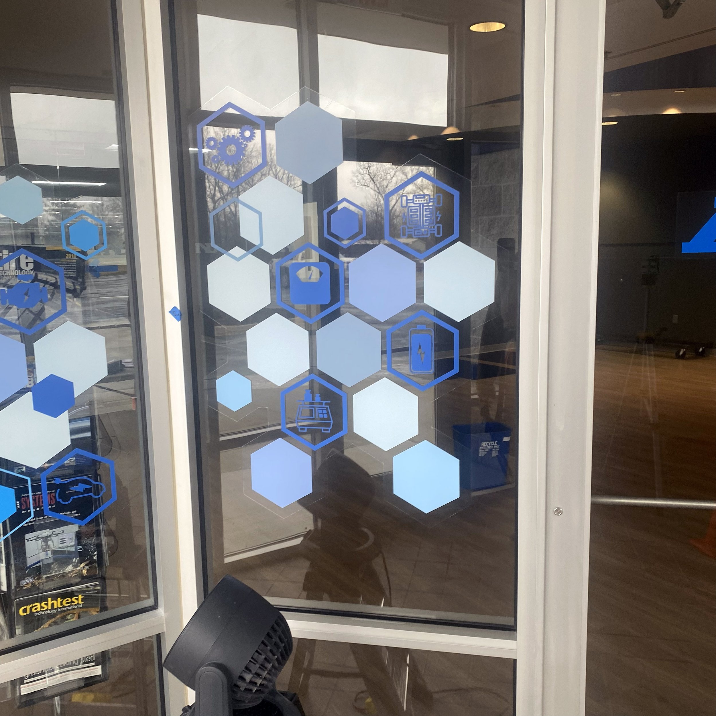 Close-up view of the final lobby glass graphics after install.