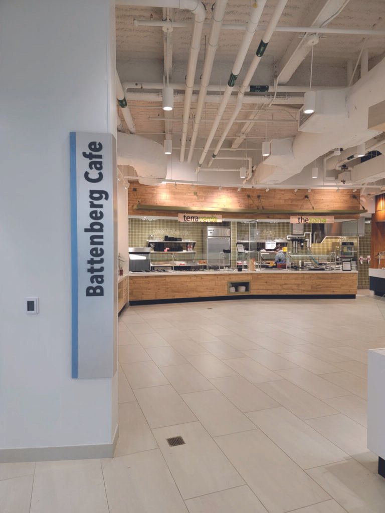 Final design and installation photo of one of the wrapped metal wayfinding signs.