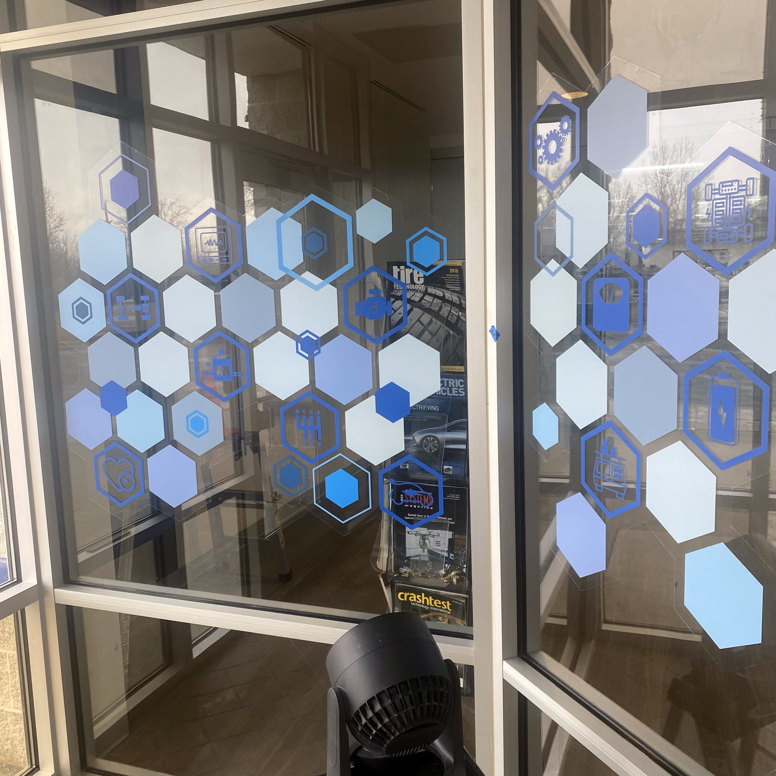 Close-up view of the final lobby glass graphics after install.