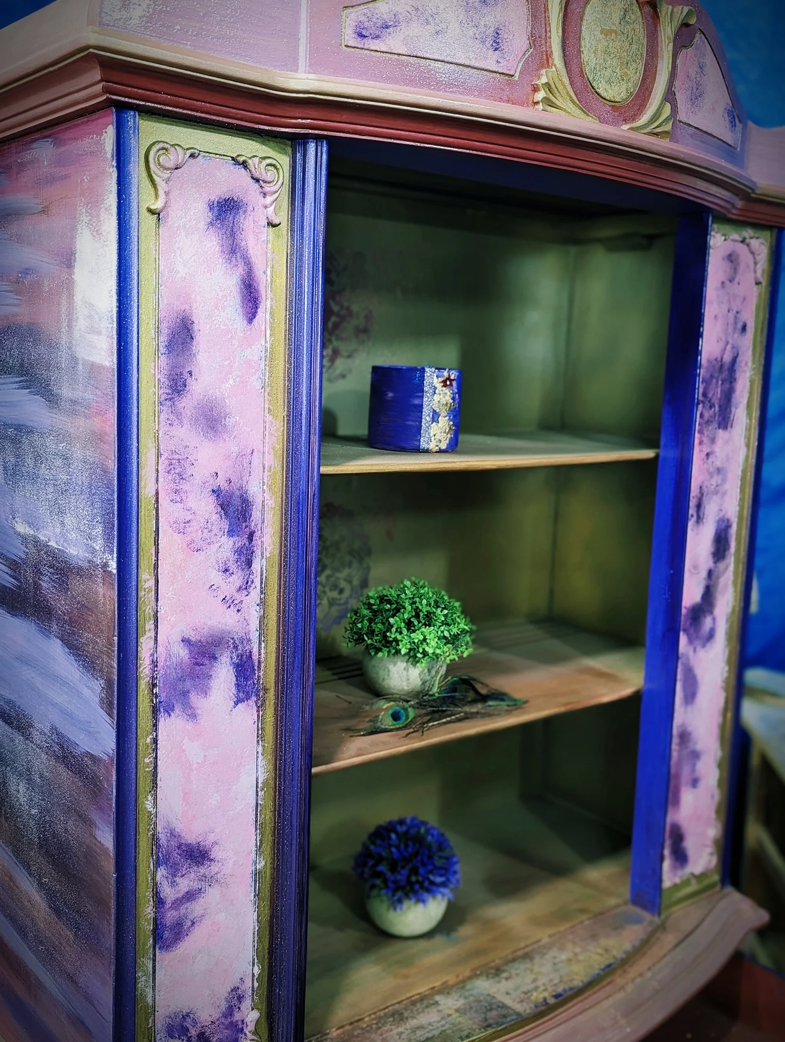 A beautifully refurbished hutch featuring a vibrant purple and blue finish with a natural wood interior, showcasing the artistic style of The Boho Soul Boutique.