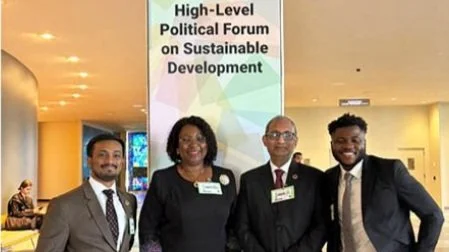 Two Millennium Fellowship Alumni standing together with their Alma Mater Vice Chancellors at the UN, with a banner in the background that reads 'High-Level Political Forum on Sustainable Development.