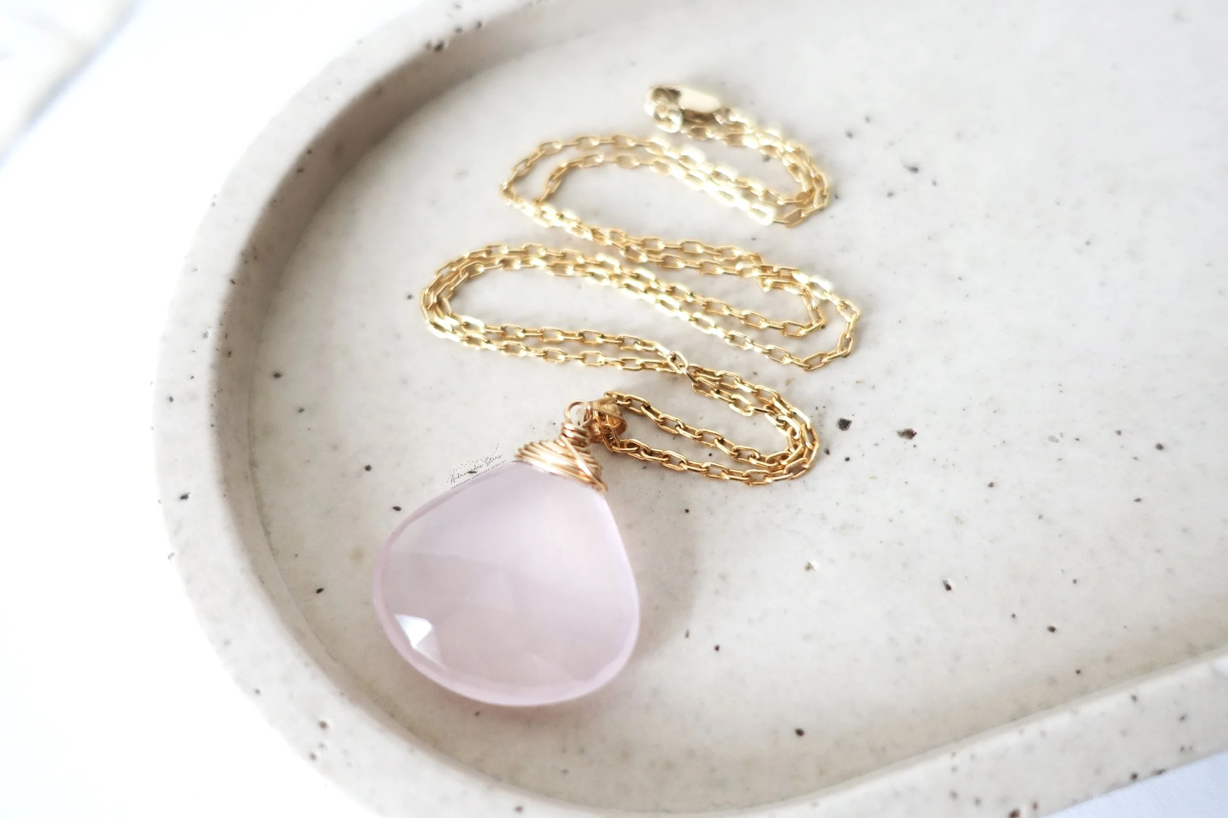 rose quartz necklace in tray.jpg