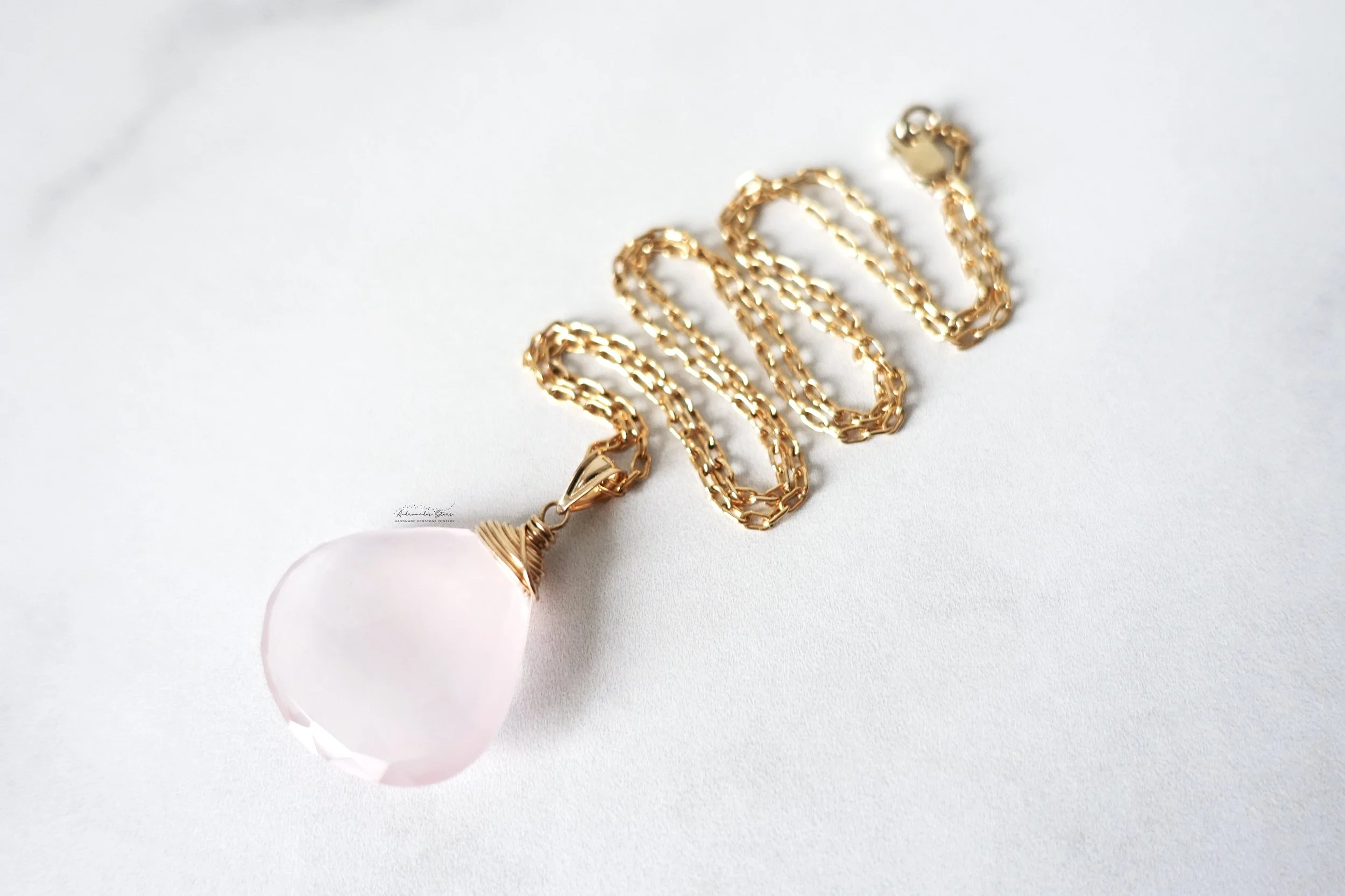 rose quartz necklace plain background.jpg