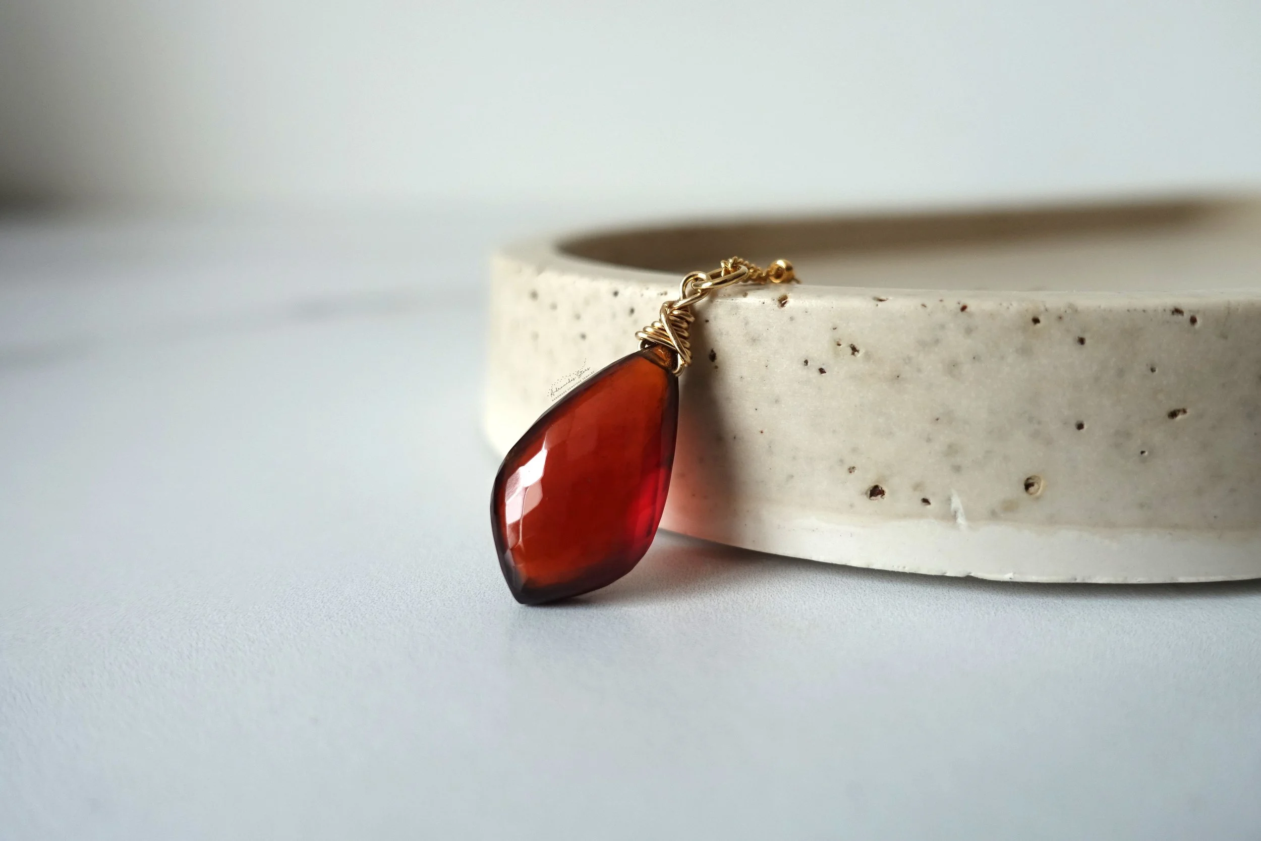 garnet pendant close up against tray.jpg