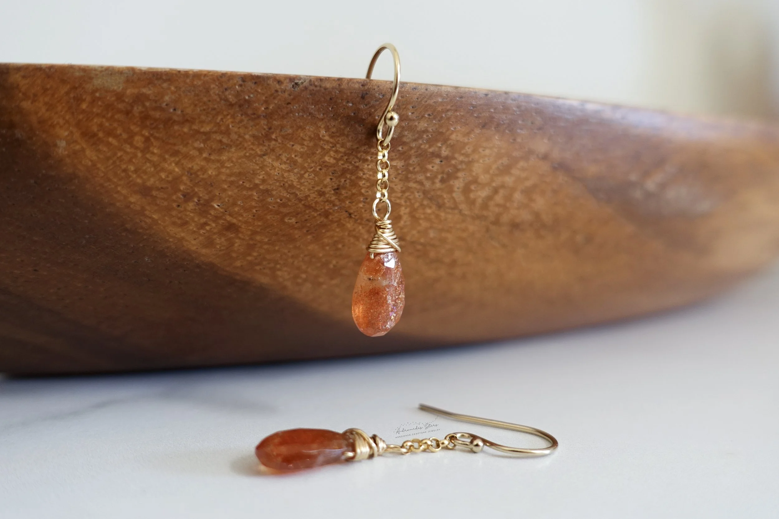 sunstone dangle earrings wooden tray.jpg