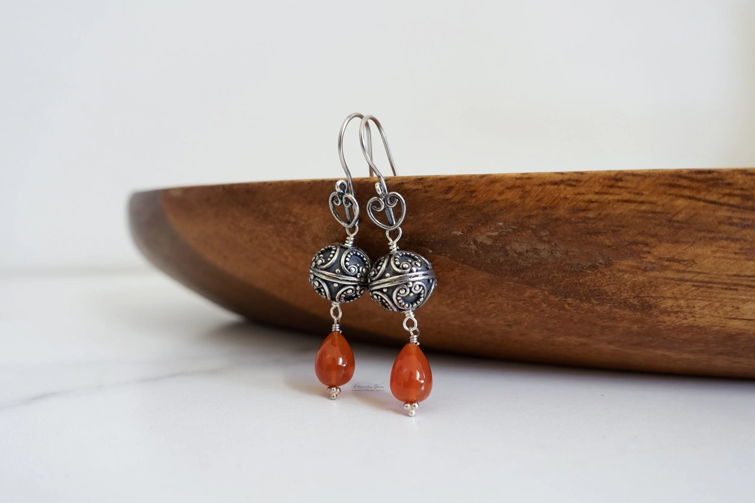 bali carnelian earrings hanging wooden tray.jpg
