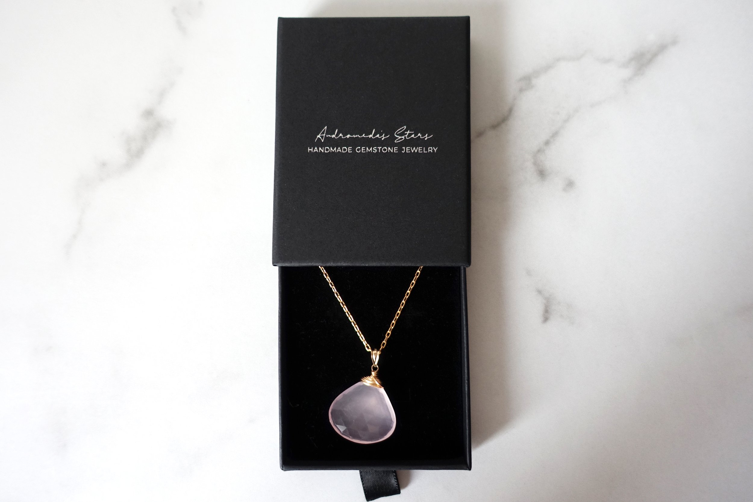 rose quartz necklace in black box.jpg