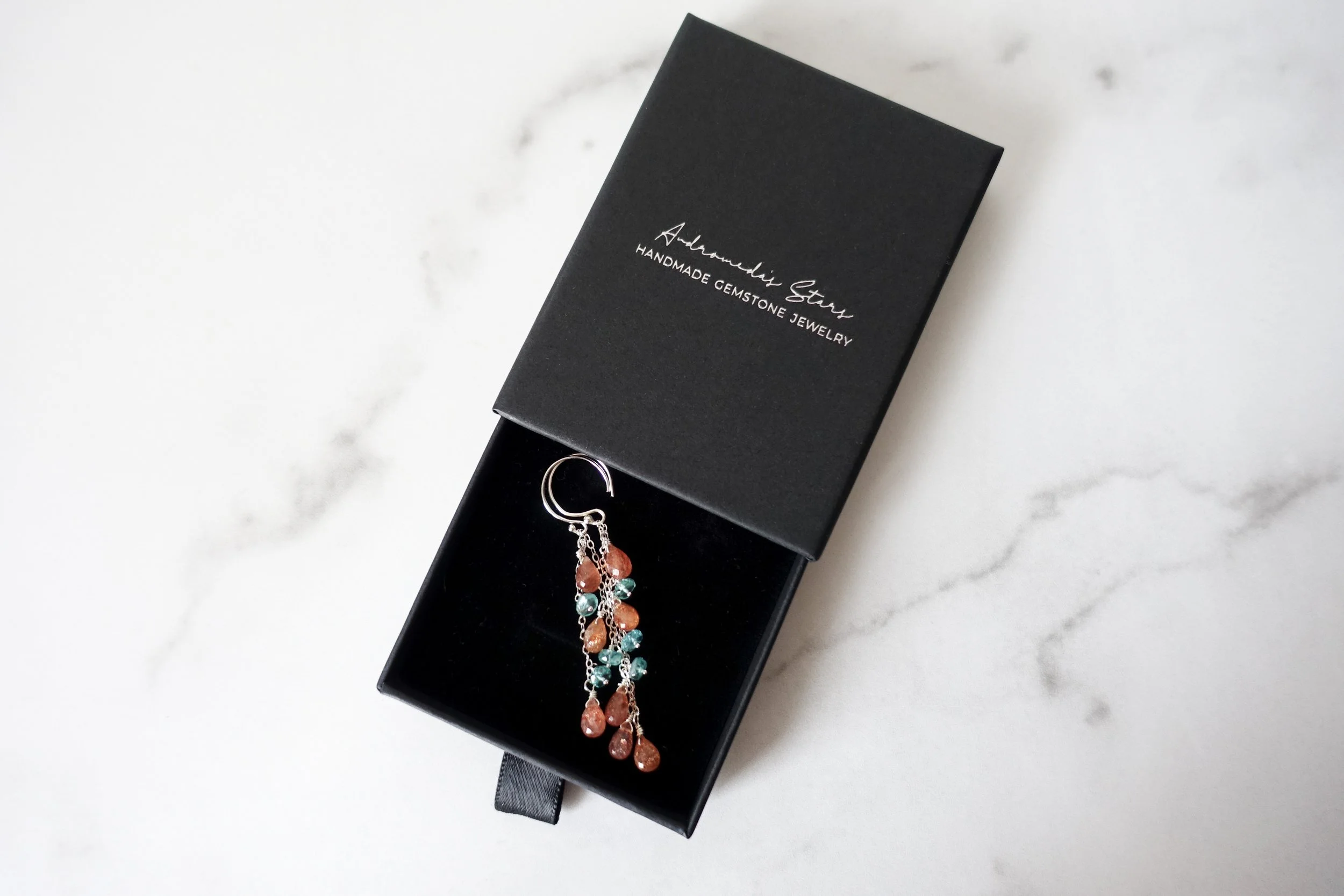 sunstone apatite dangle earrings birds eye black box.jpg