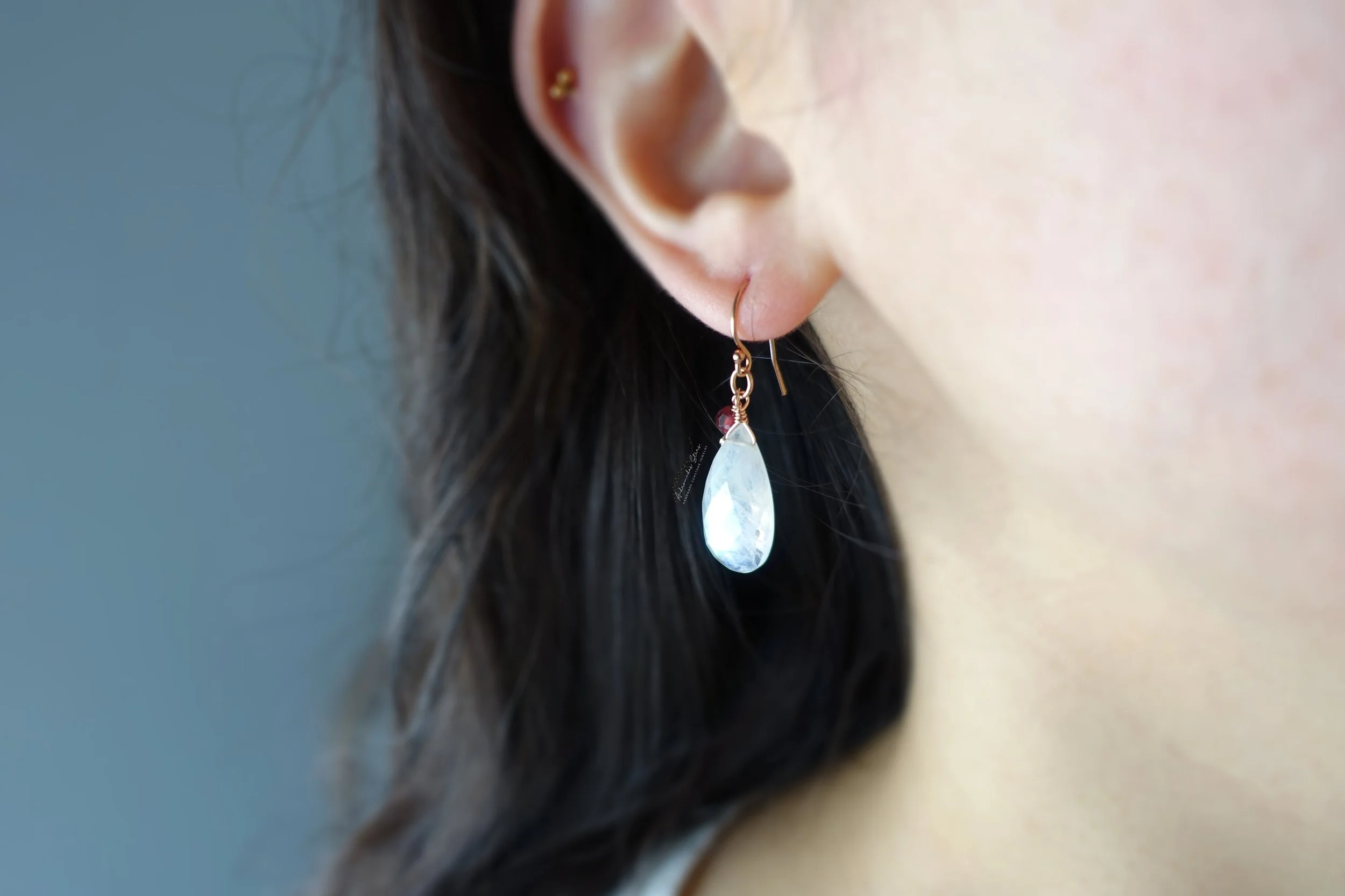 rainbow moonstone garnet rose gold earrings model.jpg