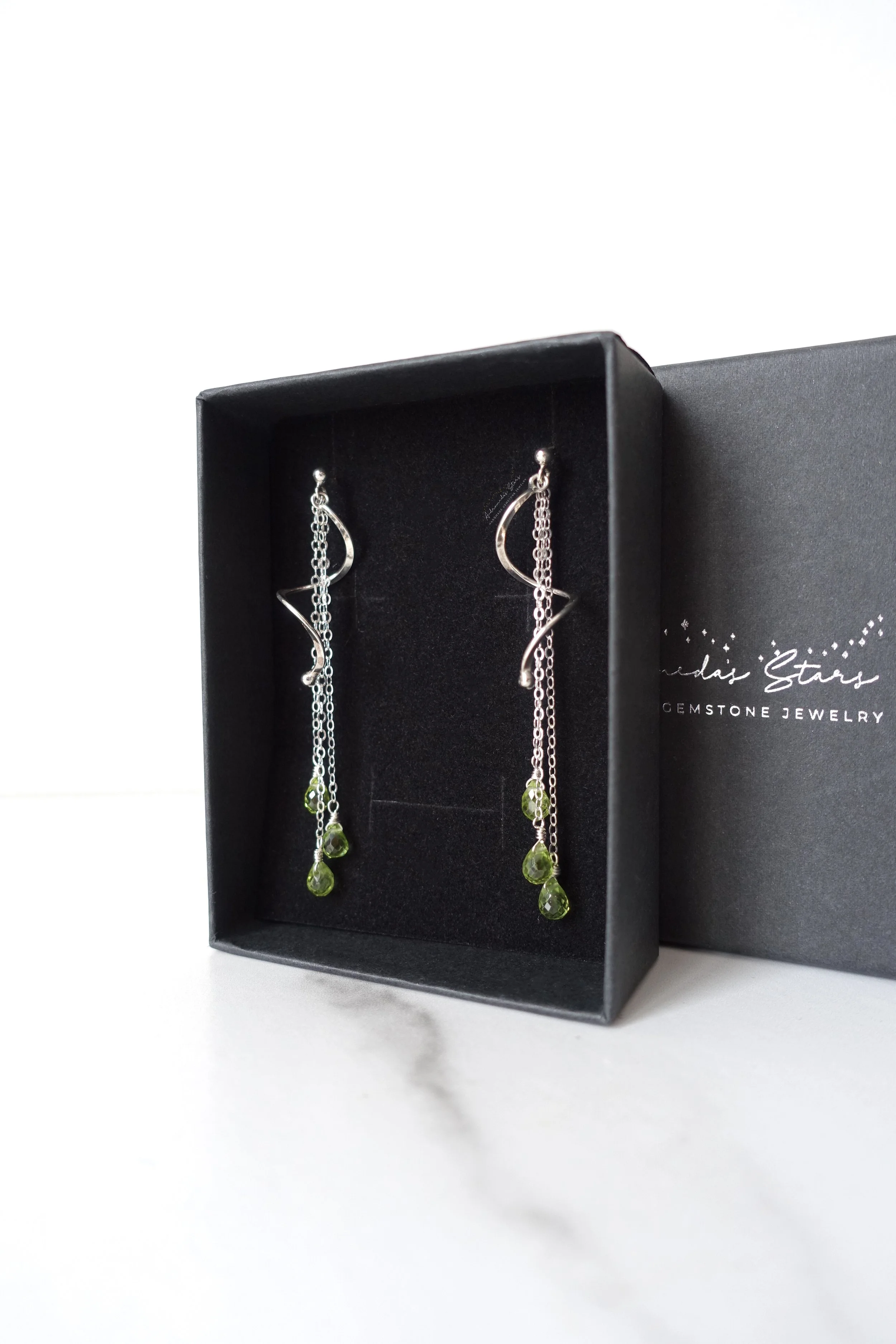 spiral peridot ss earrings in black box.jpg