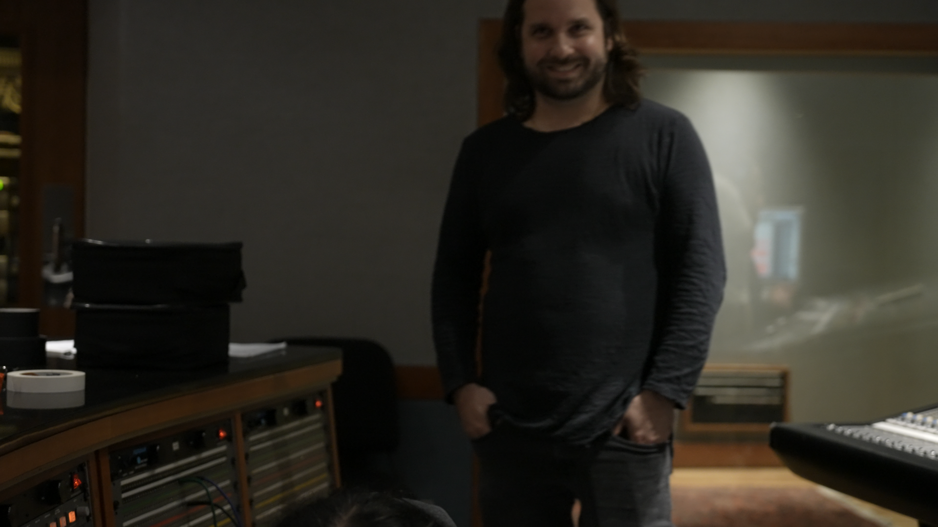 Adam smiling by gear.png