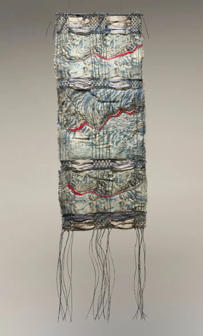 LAVAfolds #4  
Date: 2017 
Medium: Fiber, mixed media 
Materials: linen yarns, silk and cotton fabric, wood and paint 
Techniques: weaving, photographic transfer, quilting, embroidery  
Dimensions: H 34” W 9.5”