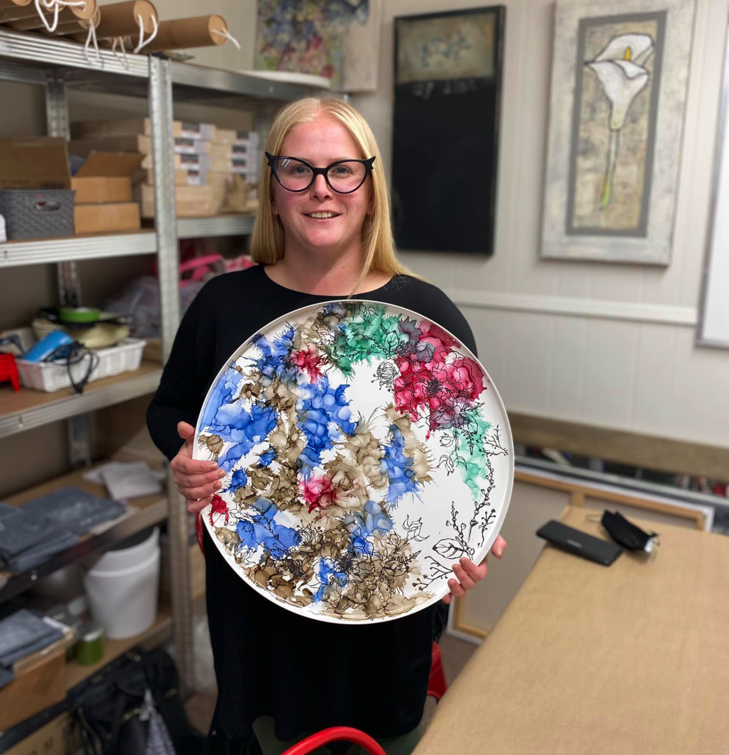 student holding painted table top
