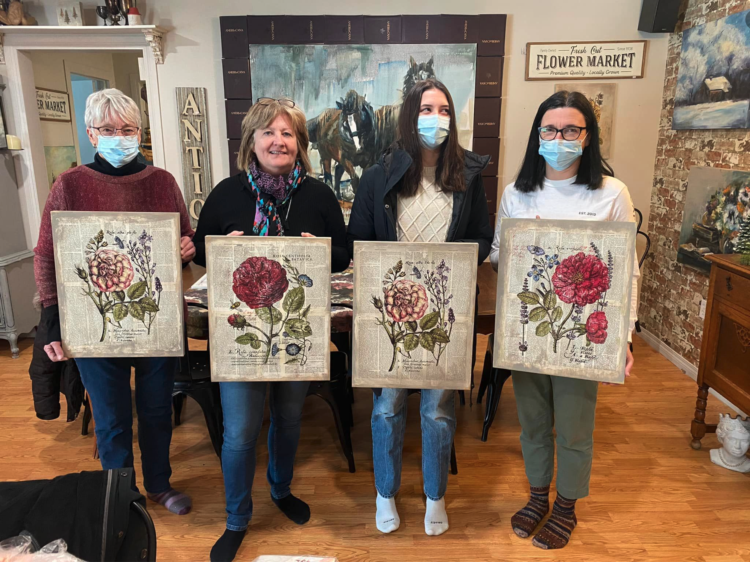 Students holding artwork