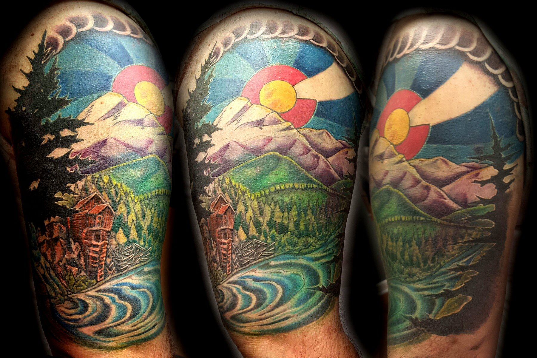 Colorful tattoo depicting a landscape scene with mountains, a river, trees, a setting sun, and a sky with stripes of blue and pink.