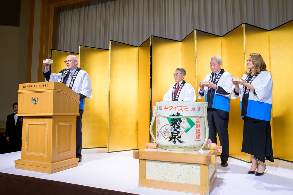  Deputy Chief Mission Raymond Greene leads the room of 270+ attendees in ringing in the new year with a celebrator kampai. 