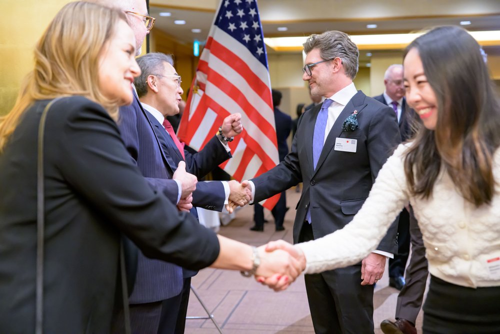  Laura Younger, Victor Osumi, James Aquilina, and Ritsuko Iinuma shake hands in the greeting line as doors open to the event. 