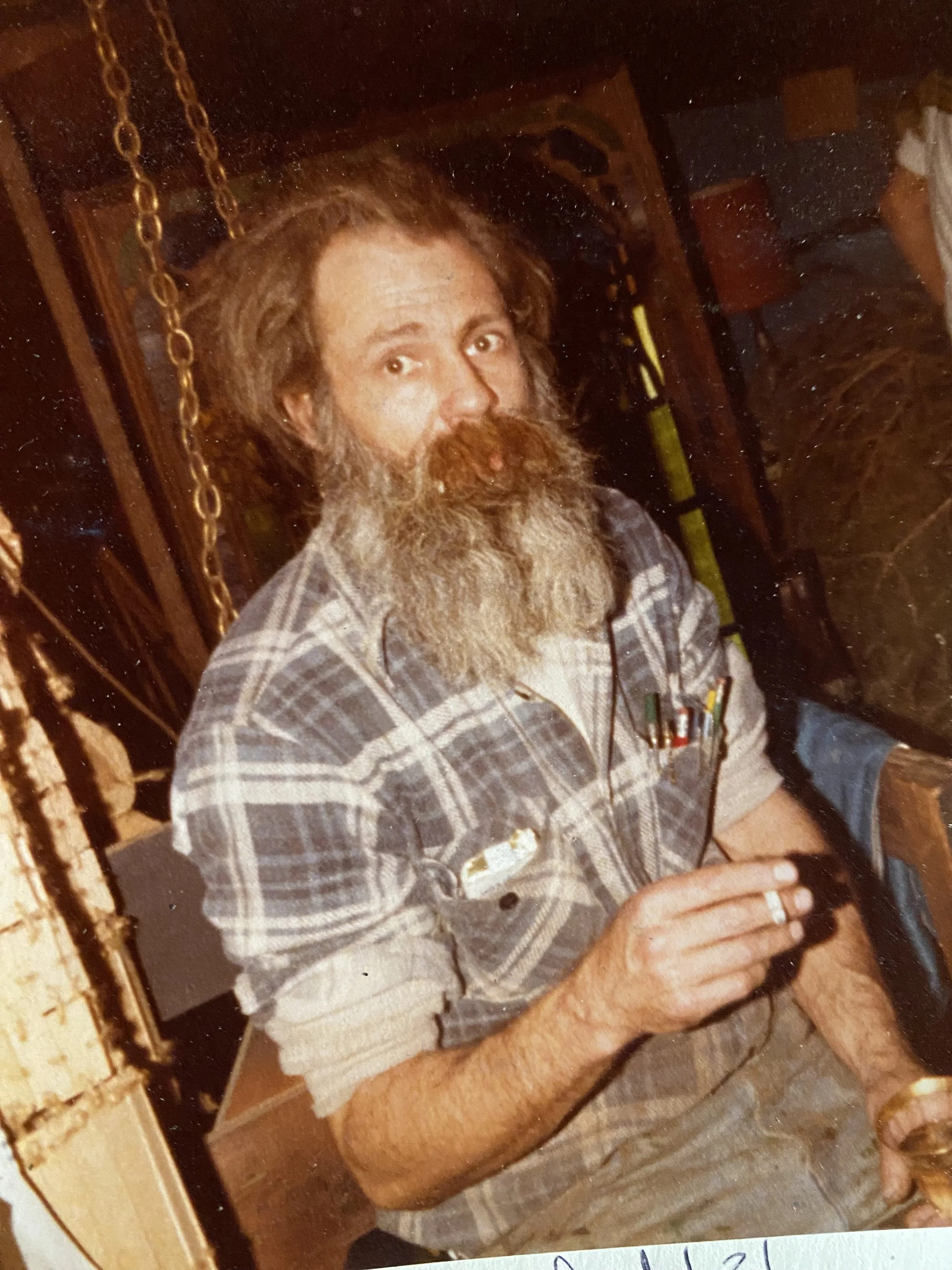 Photo of Tom Galbraith sitting down smoking a cig in his studio