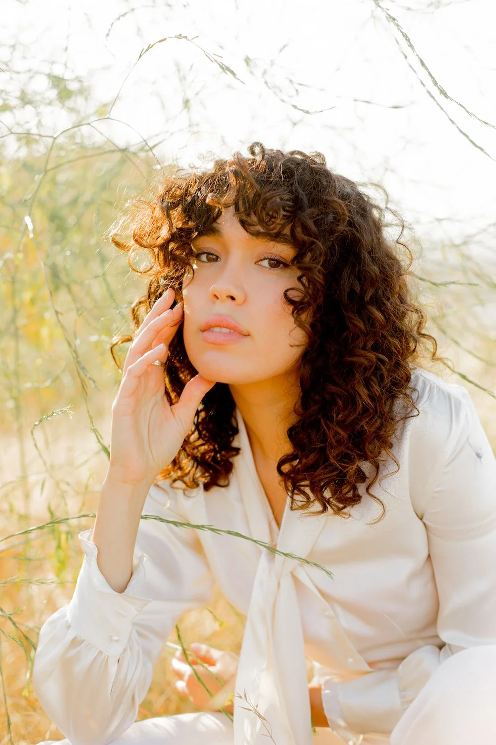 Image of a woman posing in a field.