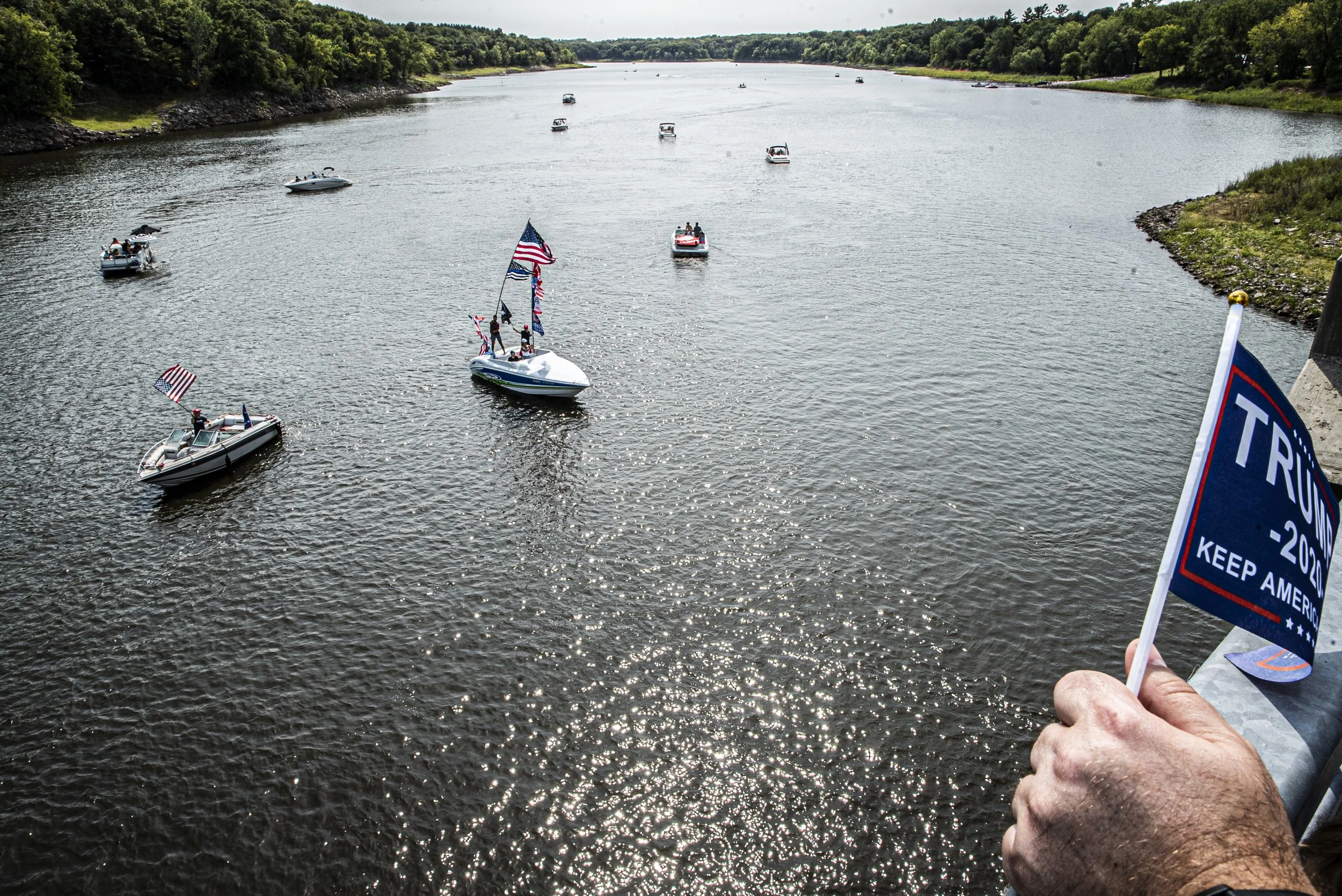  A group of boats decorated in Donald Trump paraphernalia pass under a bridge on Monday, Sept. 7, 2020. For Labor day, a group of local Trump supporters decided to drive their boats around Coralville Lake to celebrate and to show support for Presiden