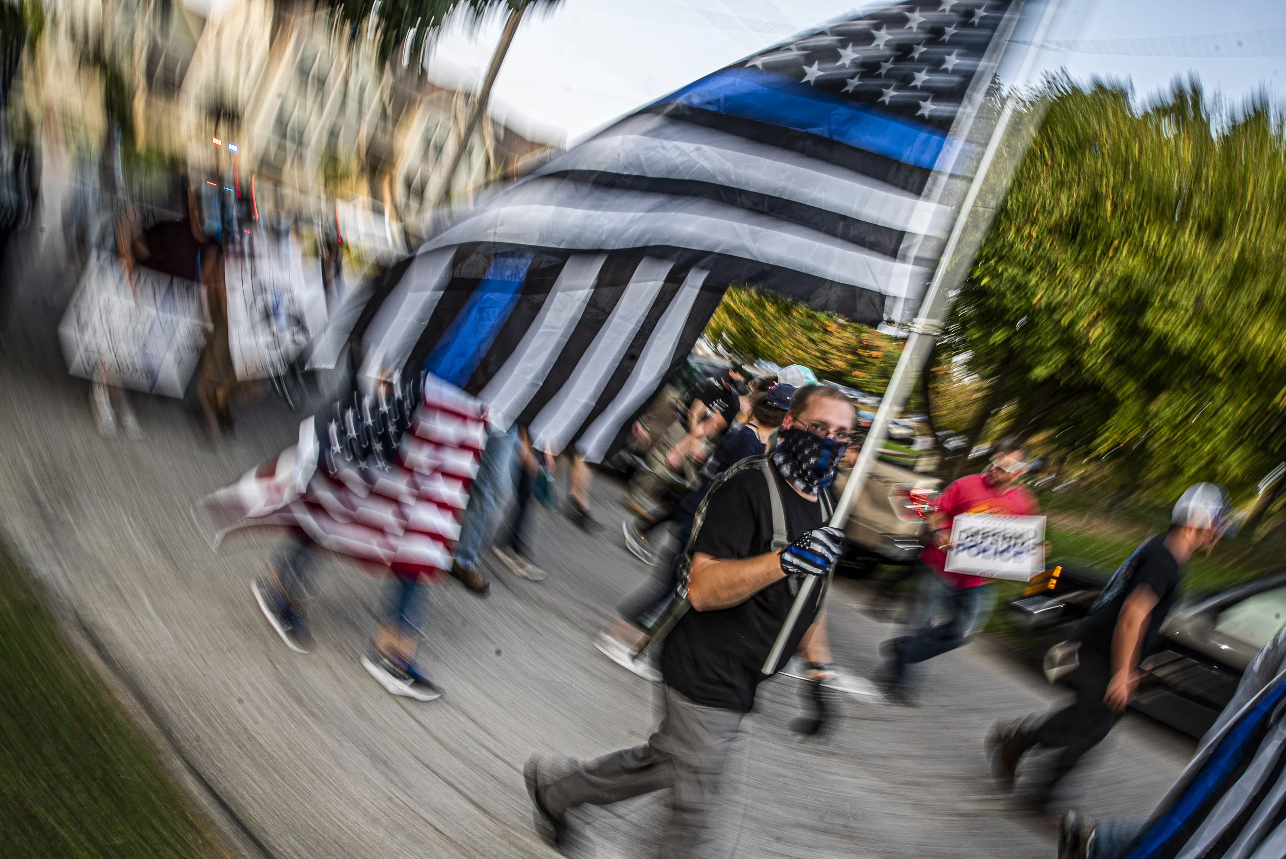  Citizens march through downtown Iowa City as part of the the Back the Blue protest on Friday, September 25th, 2020. Citizens marched through downtown Iowa City to show solidarity with the local police force and as a counter protest the Black Lives M