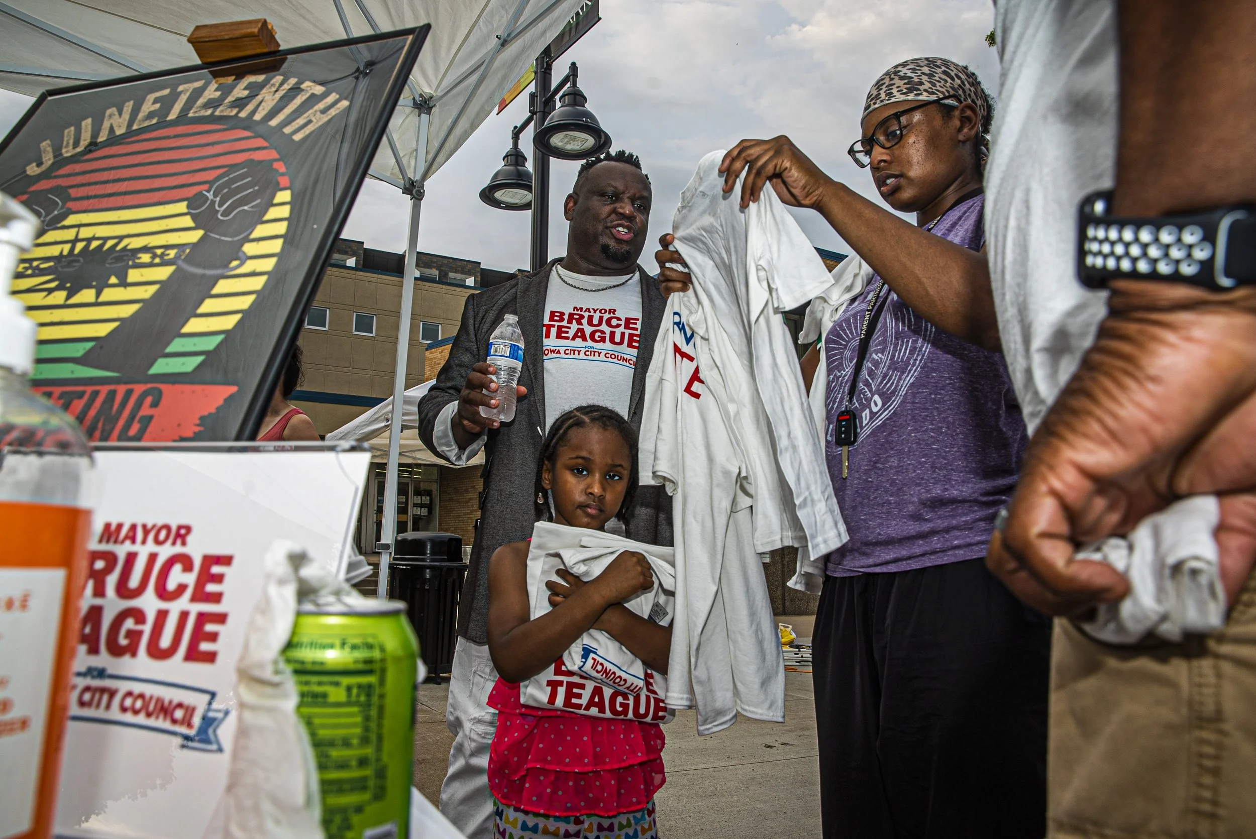  Iowa City mayor Bruce Teague hands out campaign shirts with his nieces Ariana James (left) and Candice Gordon (right) outside the Chauncey in downtown Iowa City during a Juneteenth Barbecue on Thursday, June 17th, 2021. The event was sponsored by th