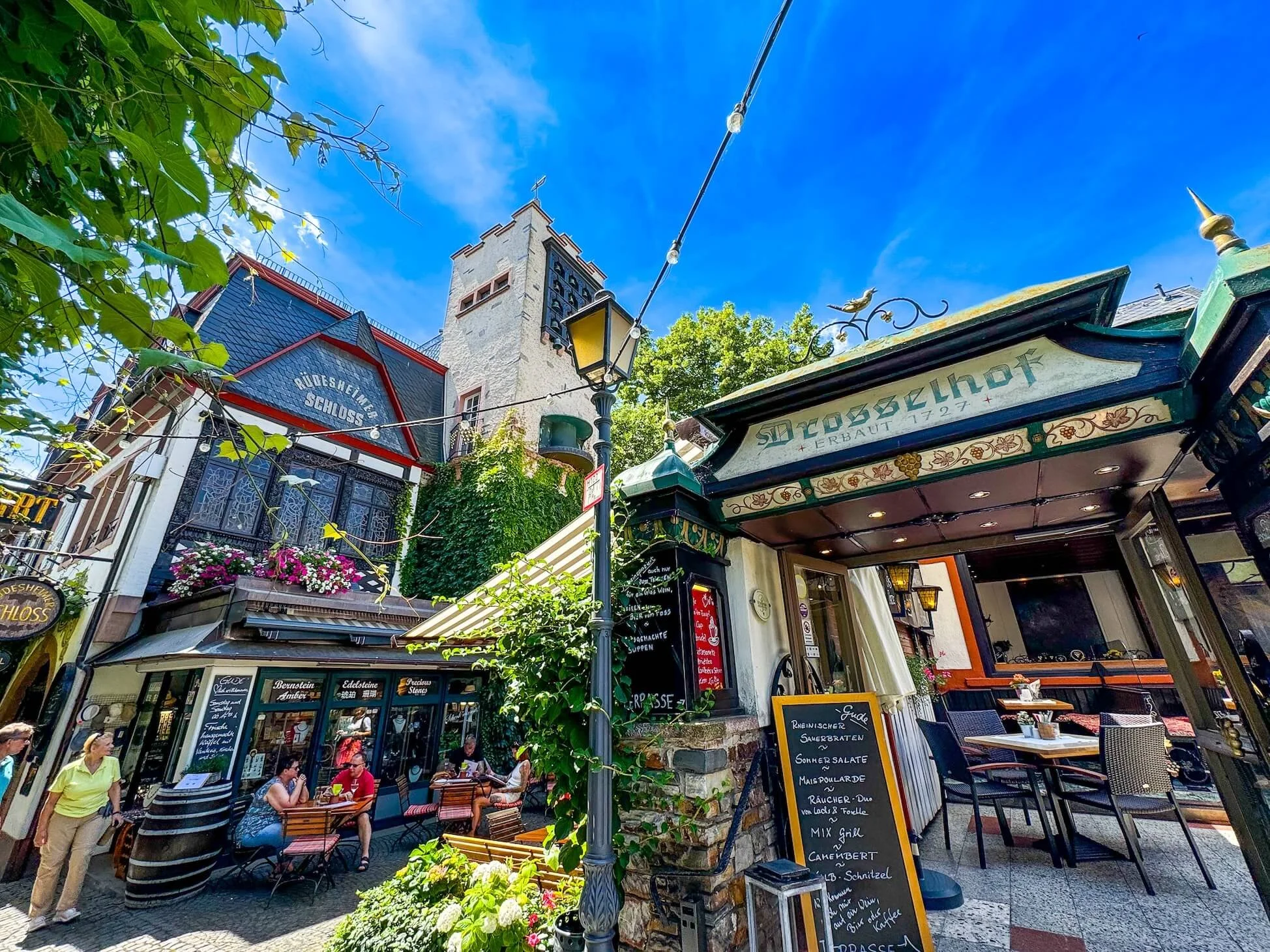 Charming alley with greenery and restaurants with outdoor seating