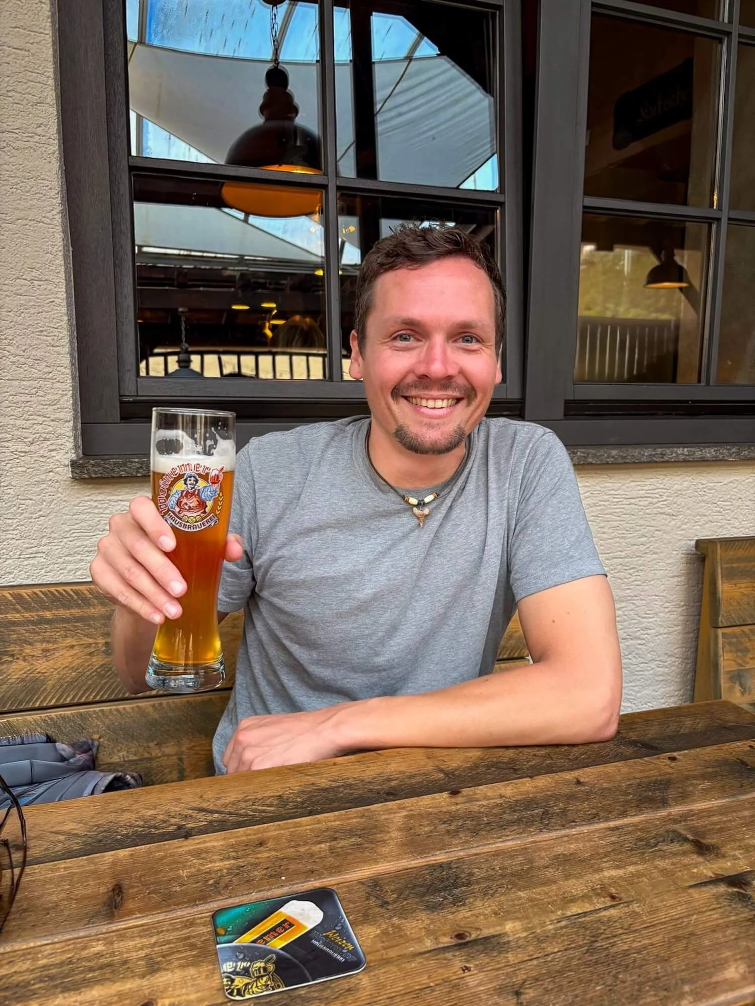 man with a German beer at a beer sitting at a table