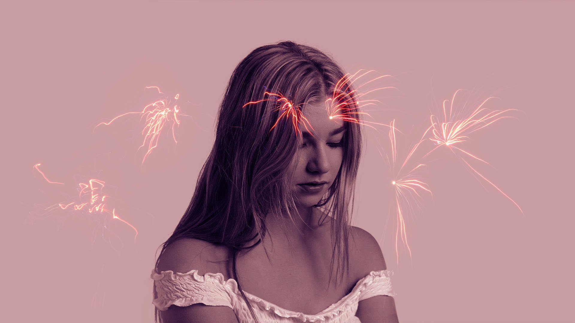 A young woman with long hair looks down, with fireworks glowing behind her on a pink background.