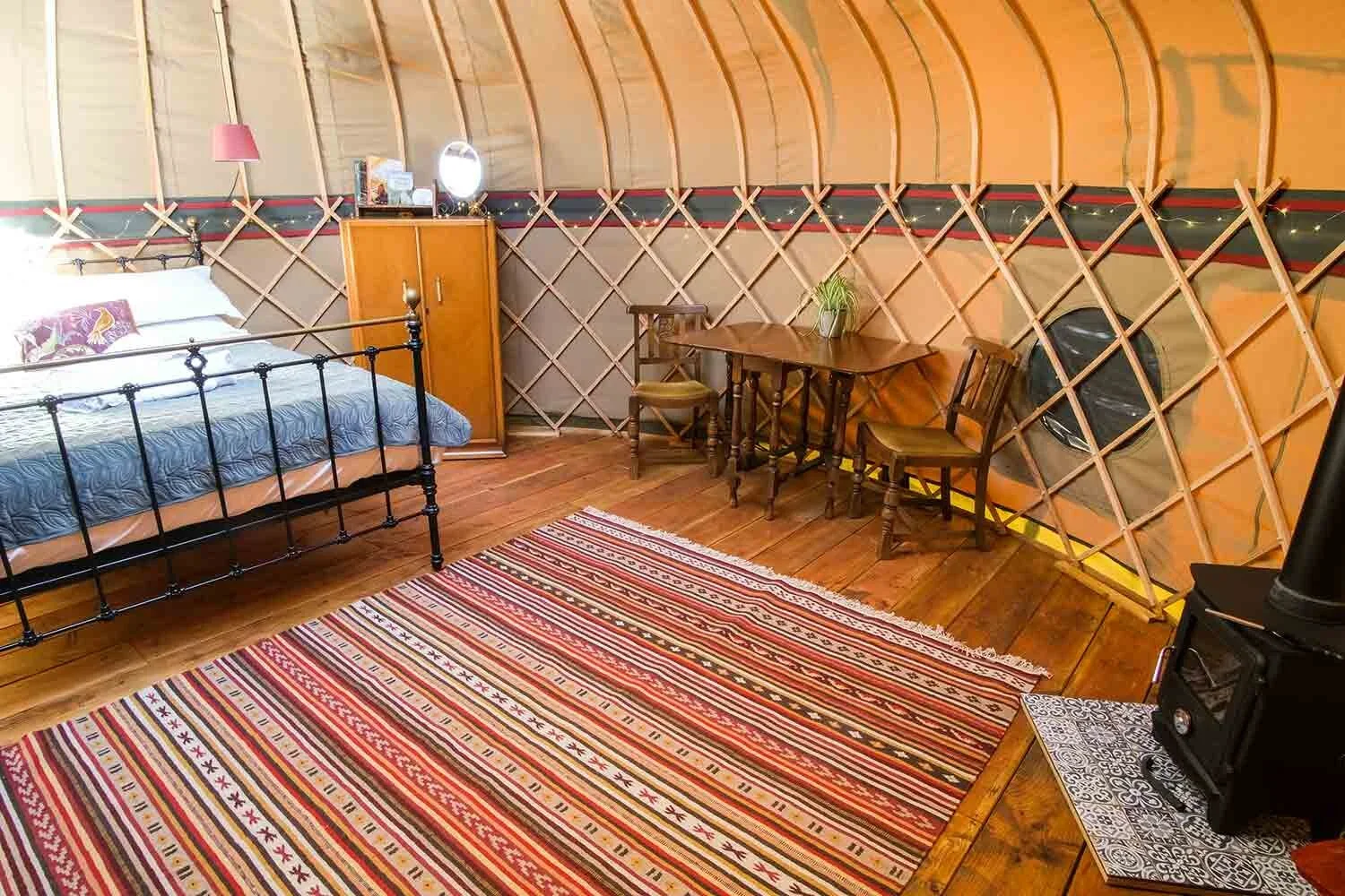 Wye-Glamping-canvas-yurts-are-styled-with-a-mix-of-antique-and-modern-furnishings.webp