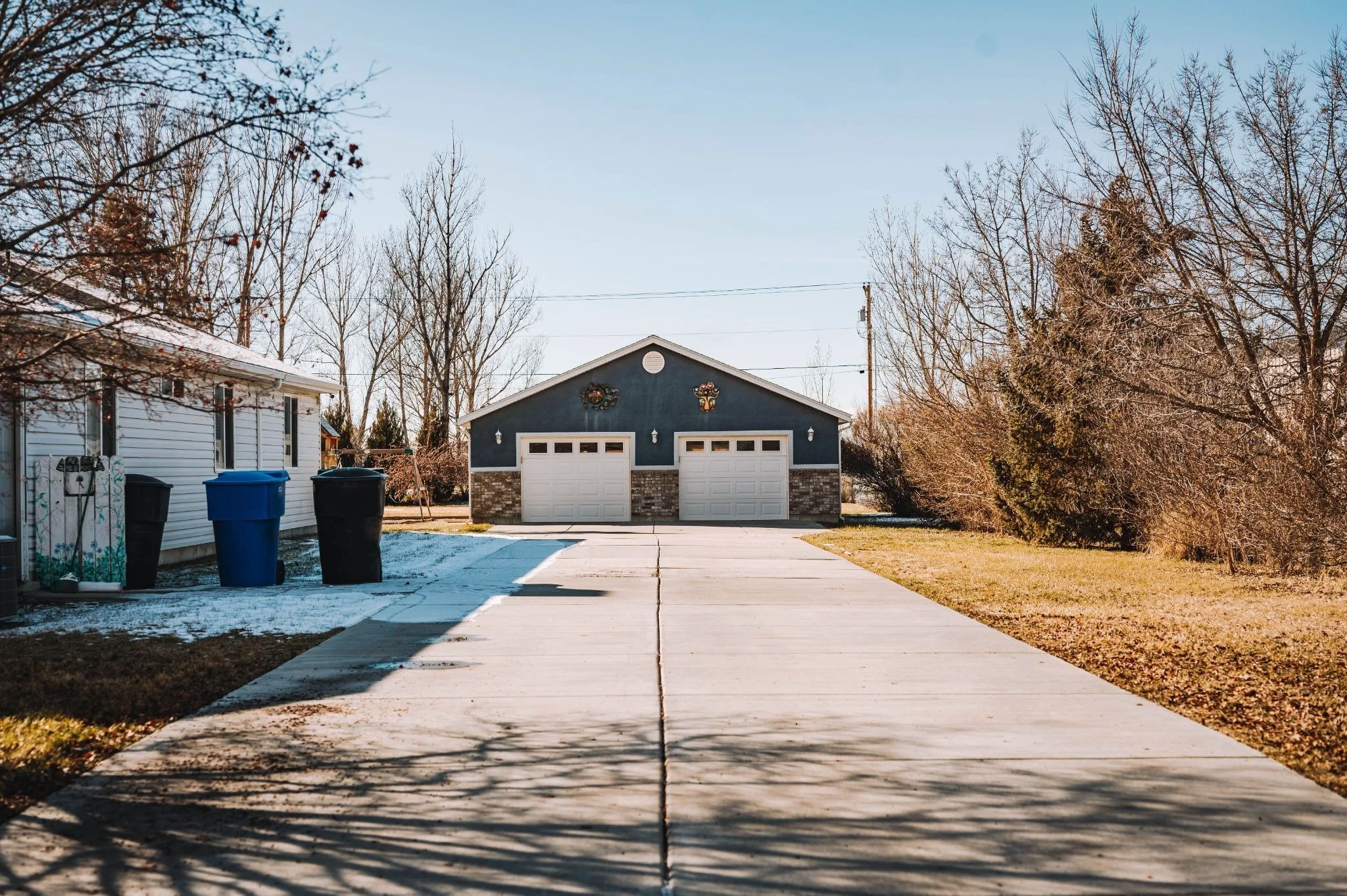 Detached garage next to a house and driveway