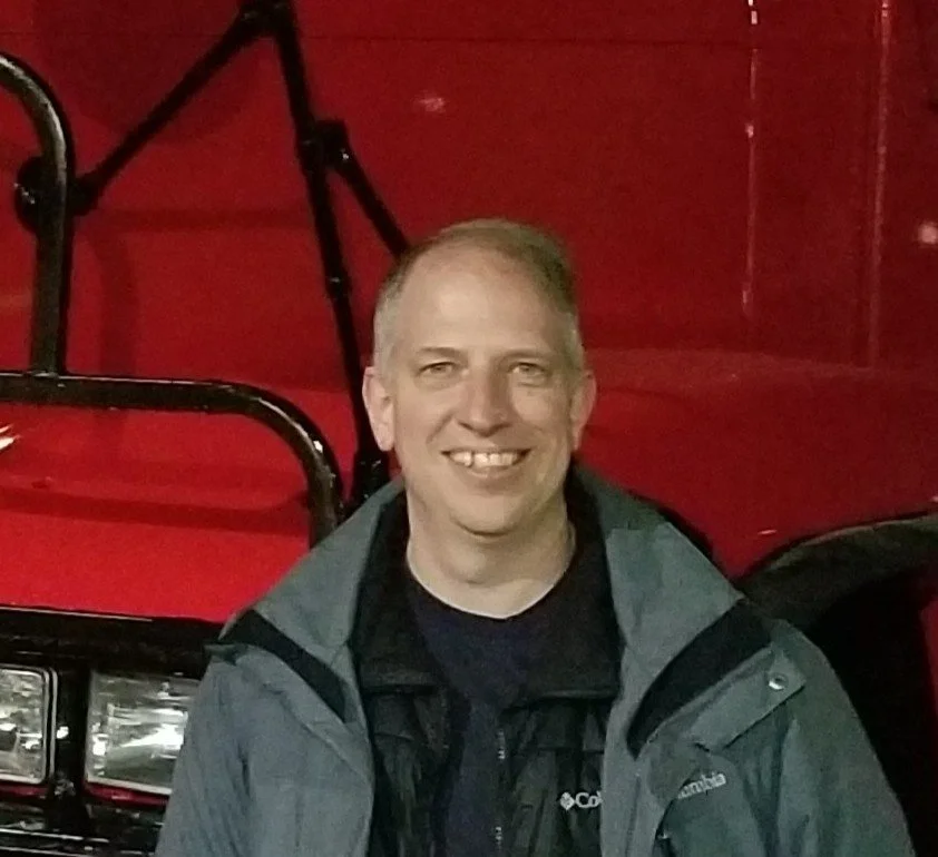 A handheld GPS device displaying a route map inside an aircraft cockpit with various gauges in the background.