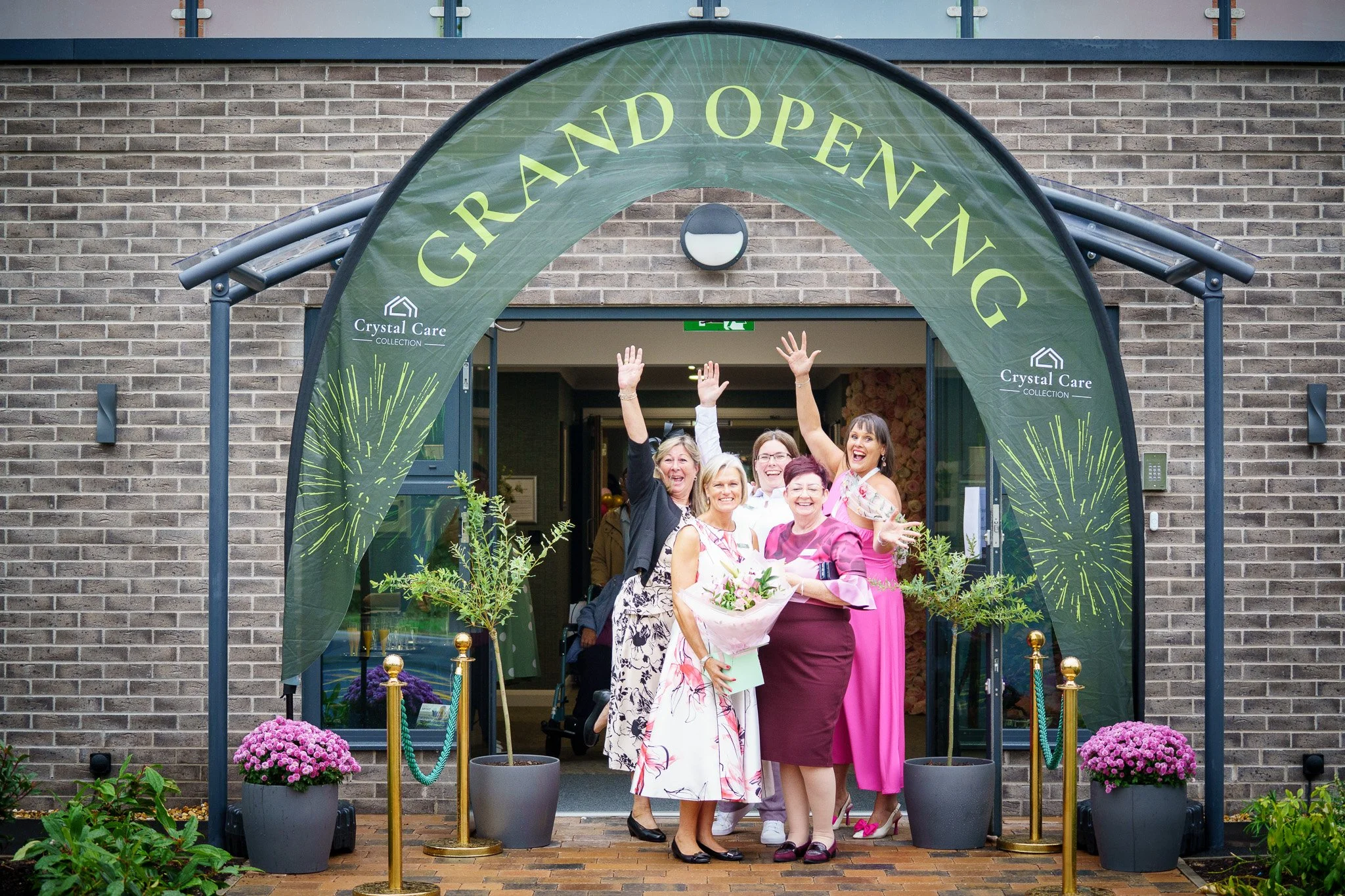 A group of women celebrating and smiling at the grand opening of 'Crystal Care home in Ellesmere Port, Cheshire