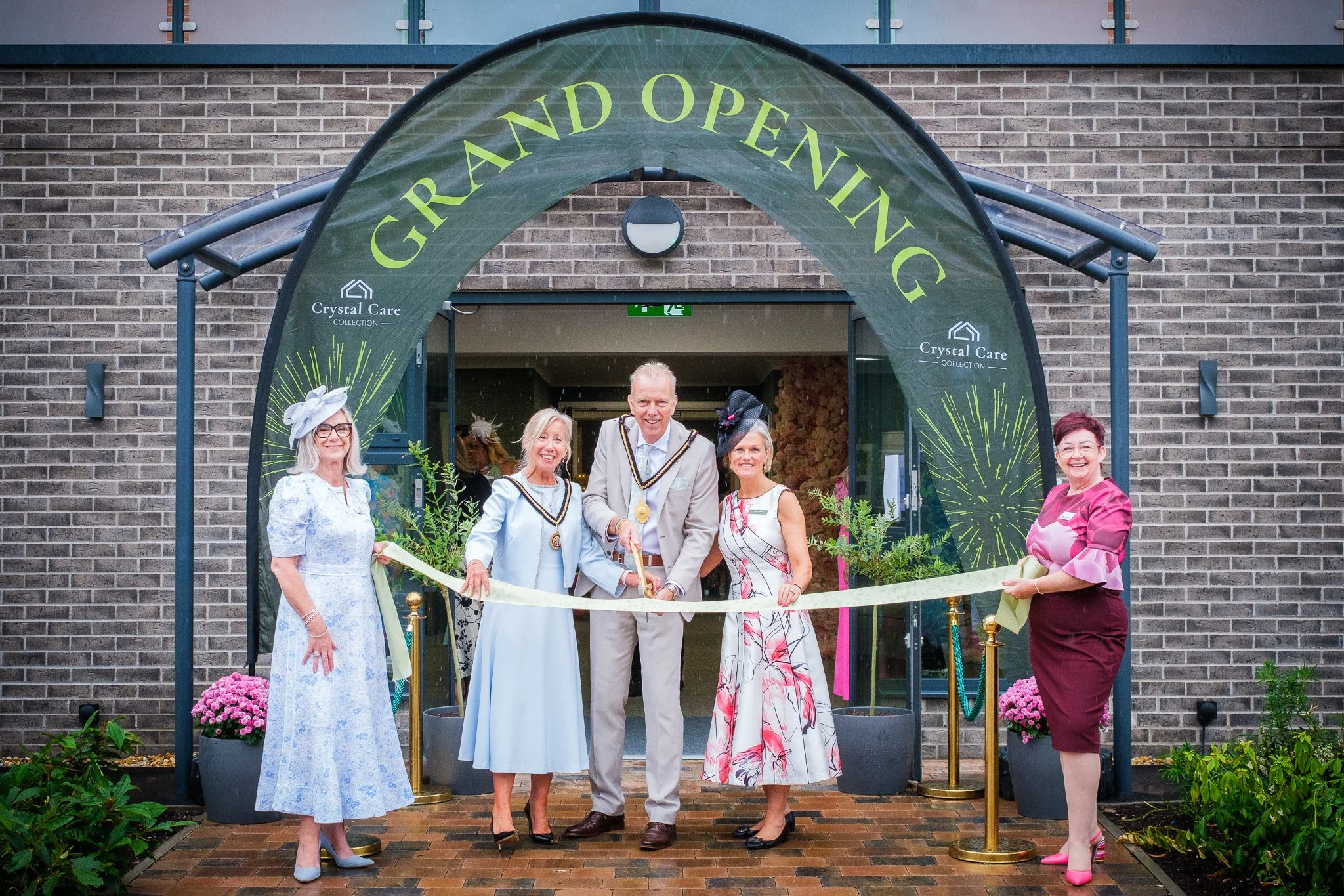 A group of people and the mayor celebrating and smiling at the grand opening of 'Crystal Care home in Ellesmere Port, Cheshire