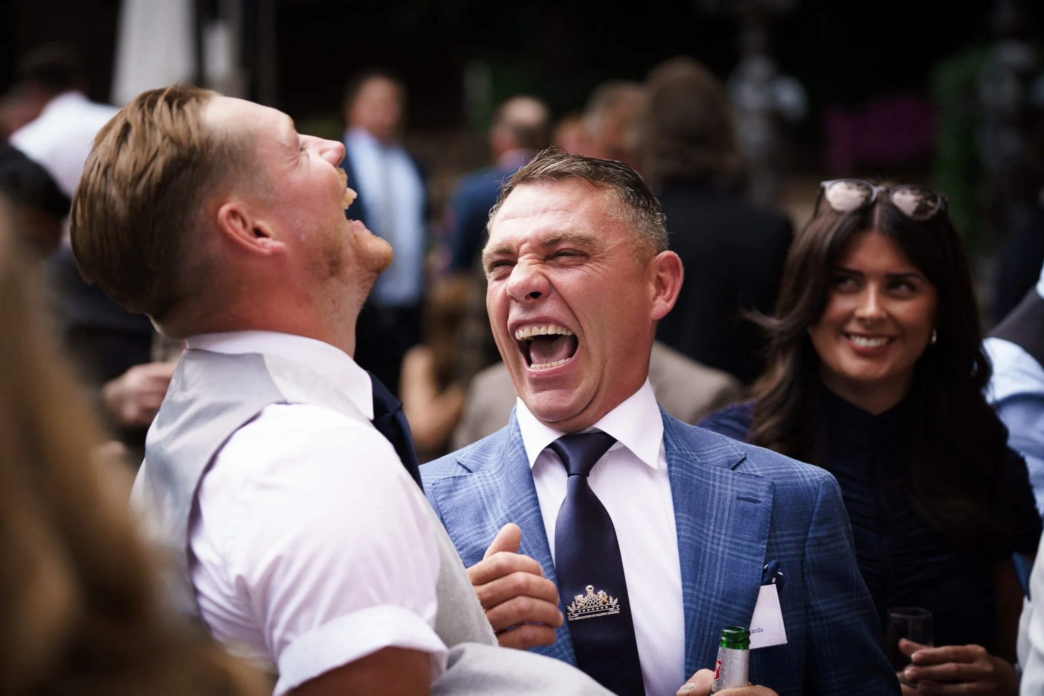 People in suits laughing at awards event in Chester, Cheshire