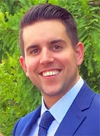 A man smiling wearing a suit